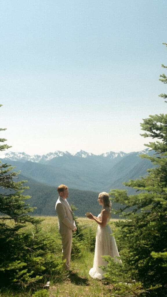 Couple exchanging vows in a mountain setting during their Oregon elopement
