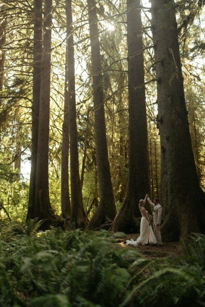 Couple standing in a forest surrounded by tall trees at a Portland, Oregon wedding venue