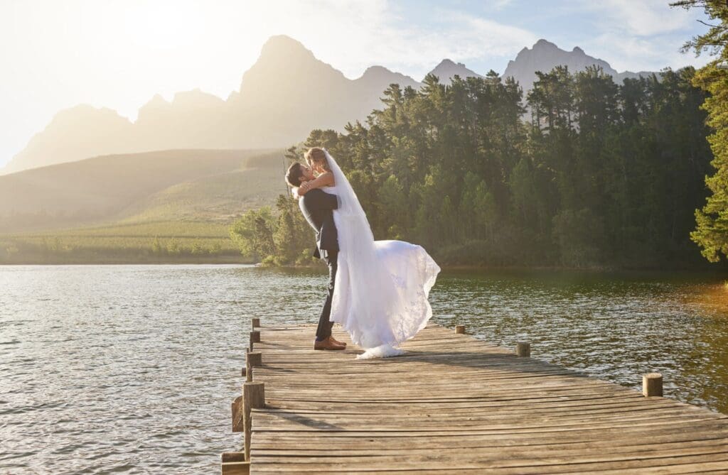 Couple embracing on a wooden dock by a lake with mountain views near Portland, Oregon