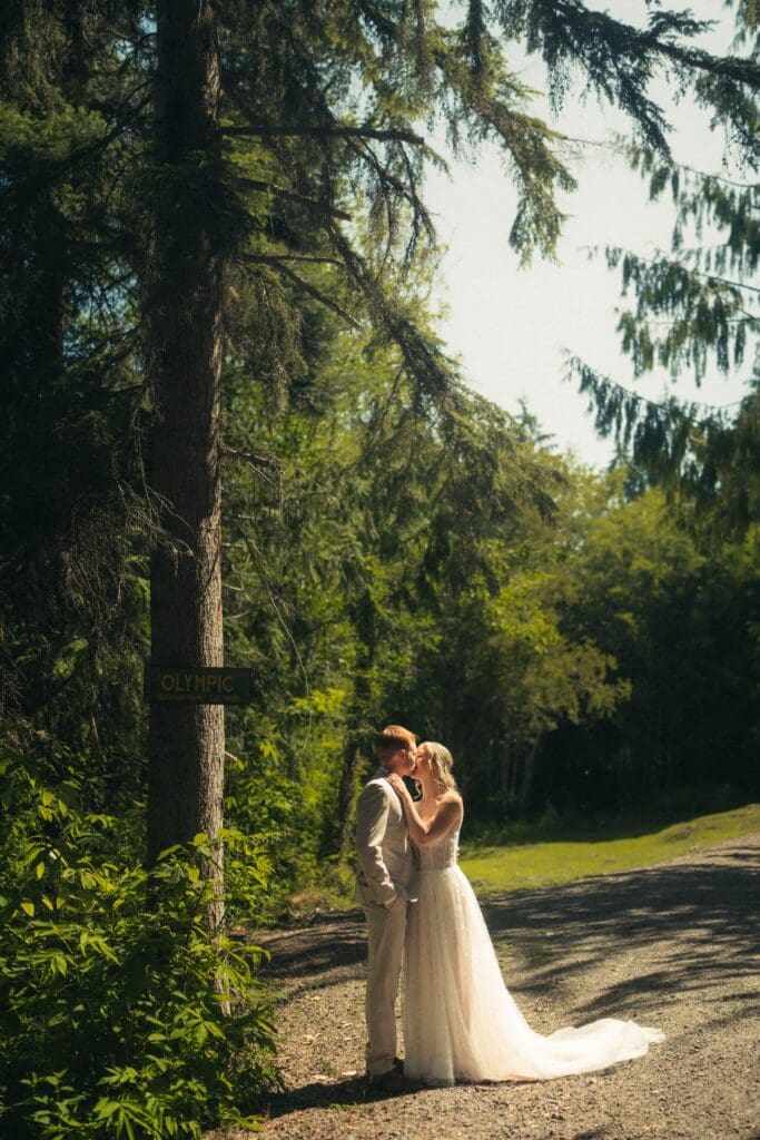 Portland Wedding Ceremony at Hoyt Arboretum featuring a couple kissing in the Portland Sun
