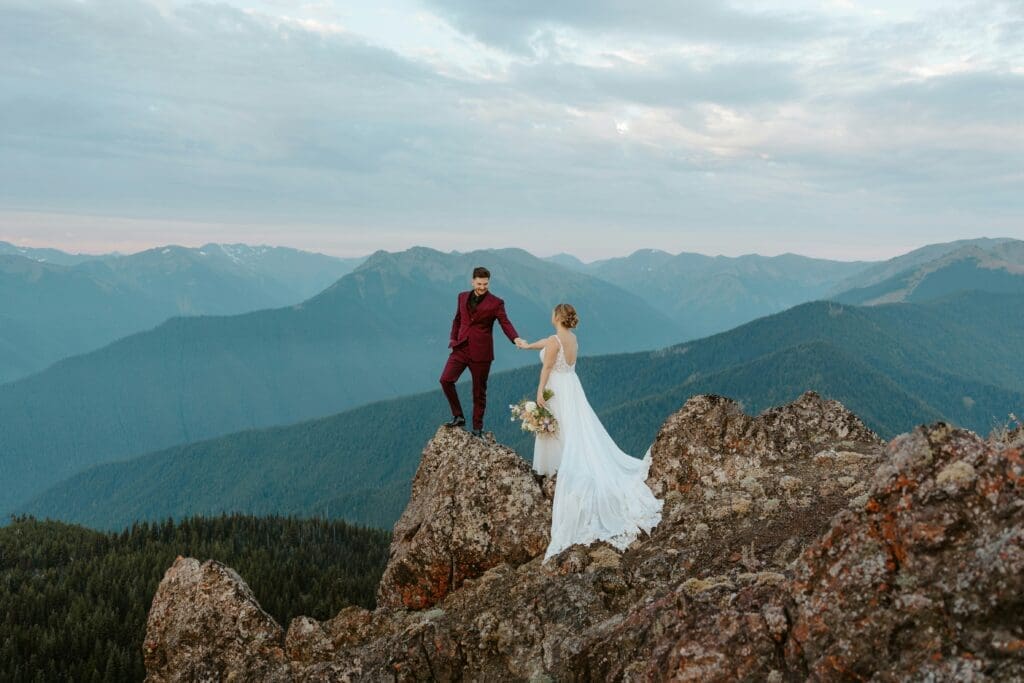 Couple standing on a mountain overlook during an adventurous Washington elopement