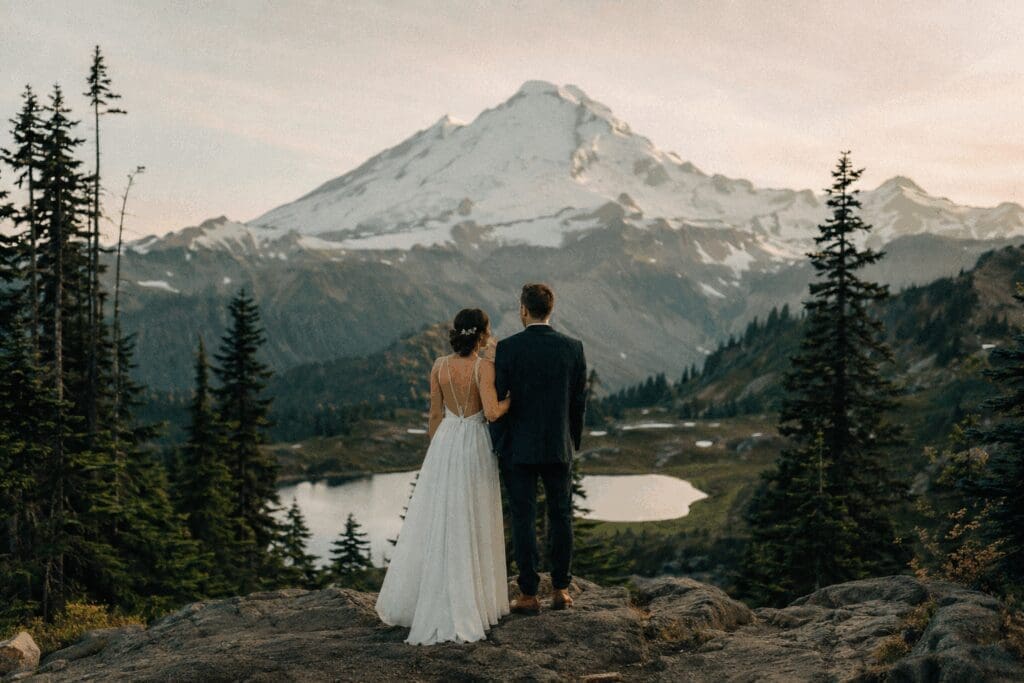 Couple standing at a scenic Mount Rainier viewpoint during an intimate Washington State elopement.