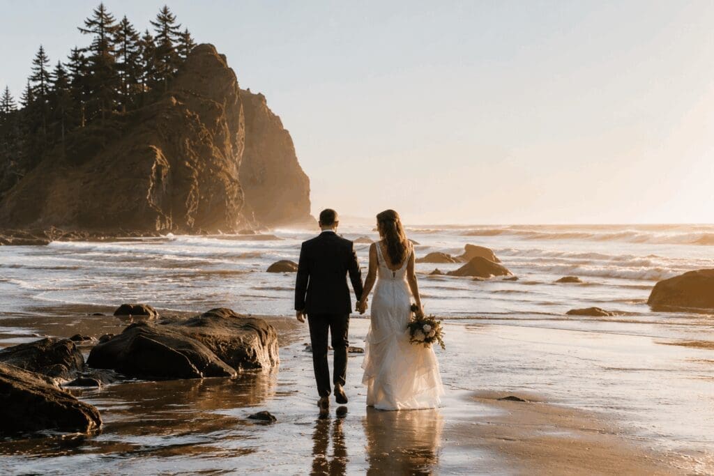 Newly married couple walking along the Oregon Coast during their Pacific Northwest elopement