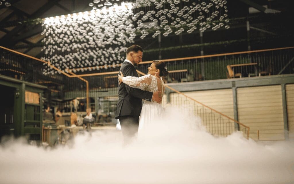 Couple dancing during a reception at a Bend Oregon micro wedding venue with modern lighting and low-lying fog, ideal for an intimate wedding in Central Oregon.