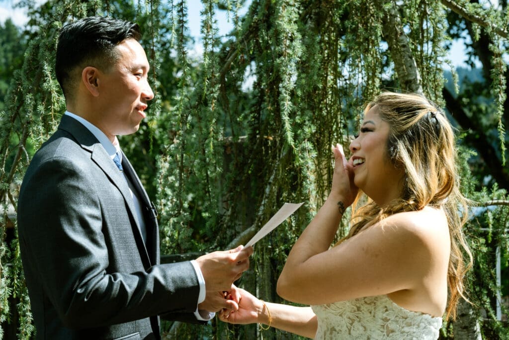 Groom reading his vows as the bride wipes happy tears during a Lake Oswego wedding at The Foundry