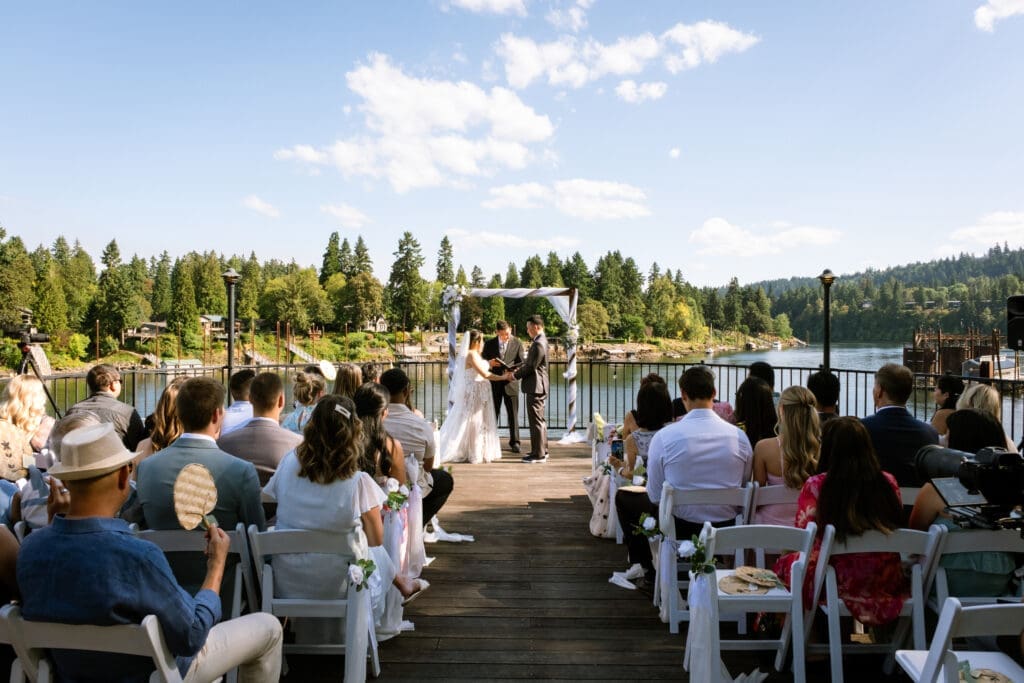 Riverside ceremony on the deck at The Foundry with guests seated, coordinated by a Lake Oswego wedding coordinator