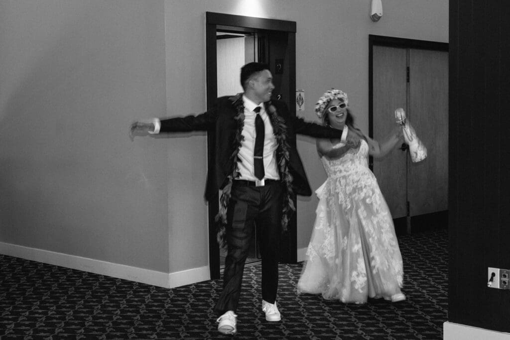 Bride and groom make a playful reception grand entrance, timed by their Portland day of wedding coordination team