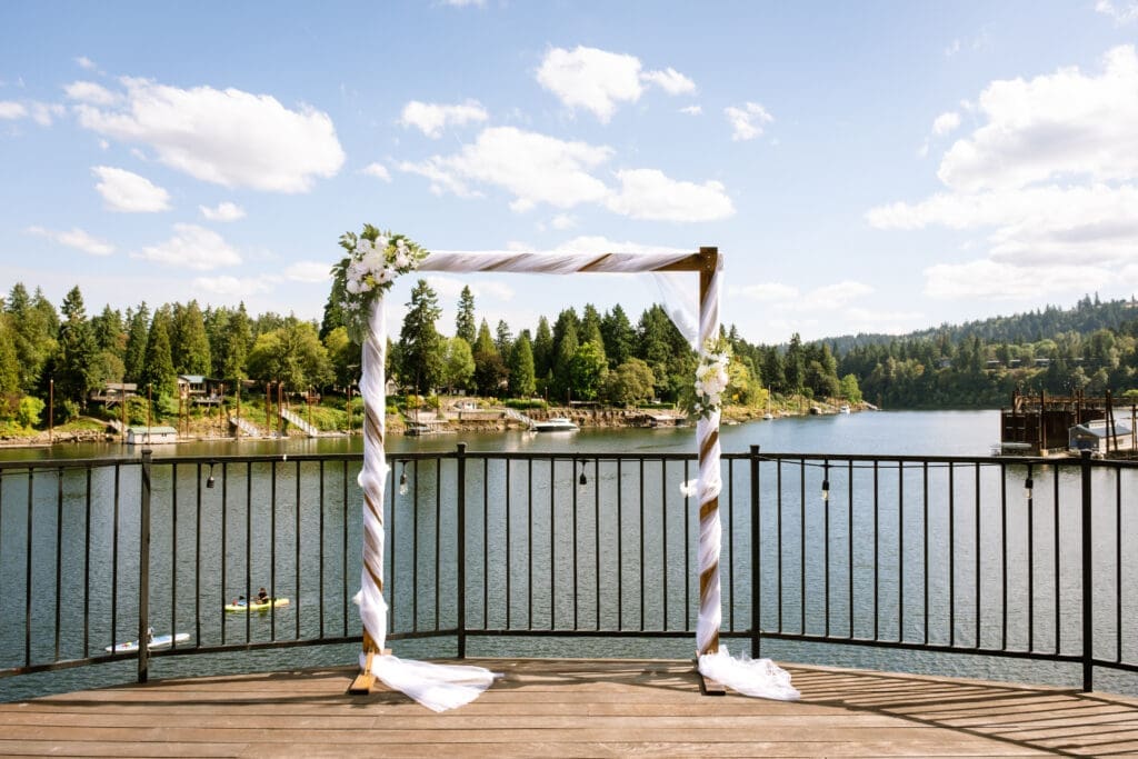 Draped ceremony arbor on the riverside deck at The Foundry, set up by a Lake Oswego wedding coordinator