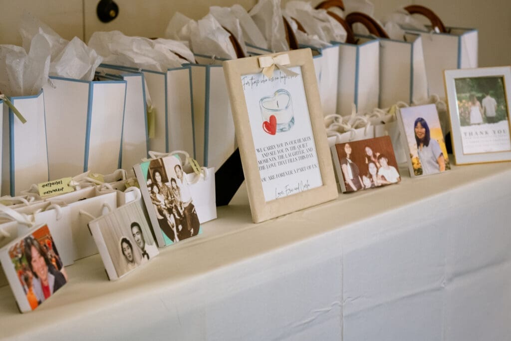 Welcome table with guest gift bags and framed family photos at The Foundry in Lake Oswego
