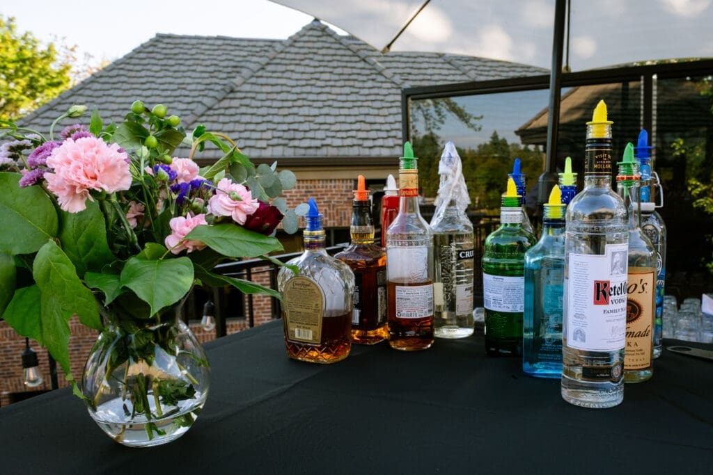 Outdoor bar set up with florals on the deck at a Portland intimate wedding reception