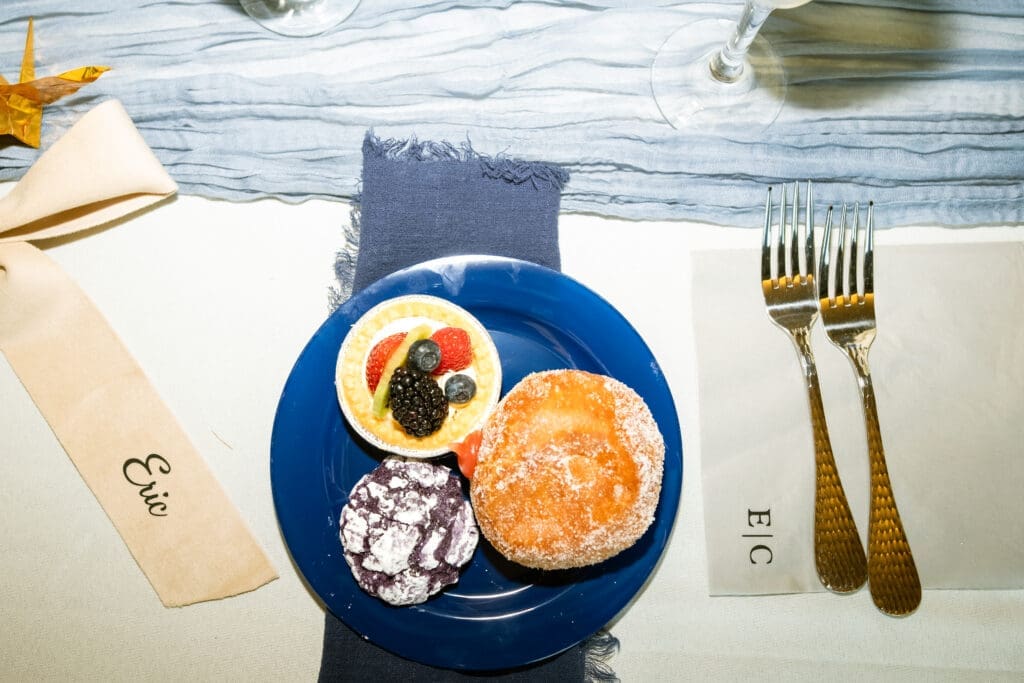Place setting with a dessert plate and gold flatware at Eric and Carla's Lake Oswego wedding reception