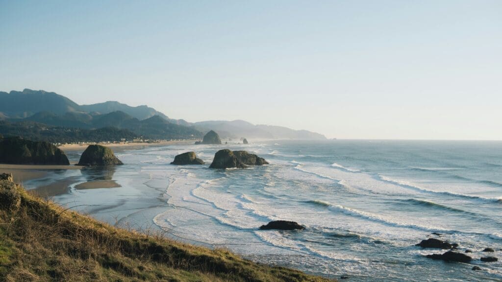Haystack Rock rising from the shoreline at Cannon Beach, Oregon
