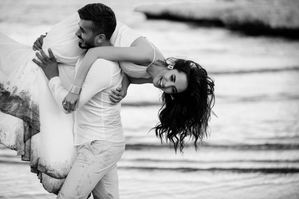 Newlywed couple embracing on the beach during a joyful Oregon Coast elopement near Lincoln City.