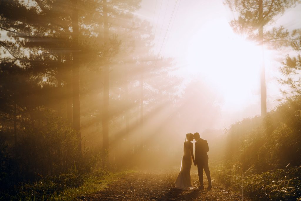 Couple sharing a quiet moment during an intimate forest elopement at sunset