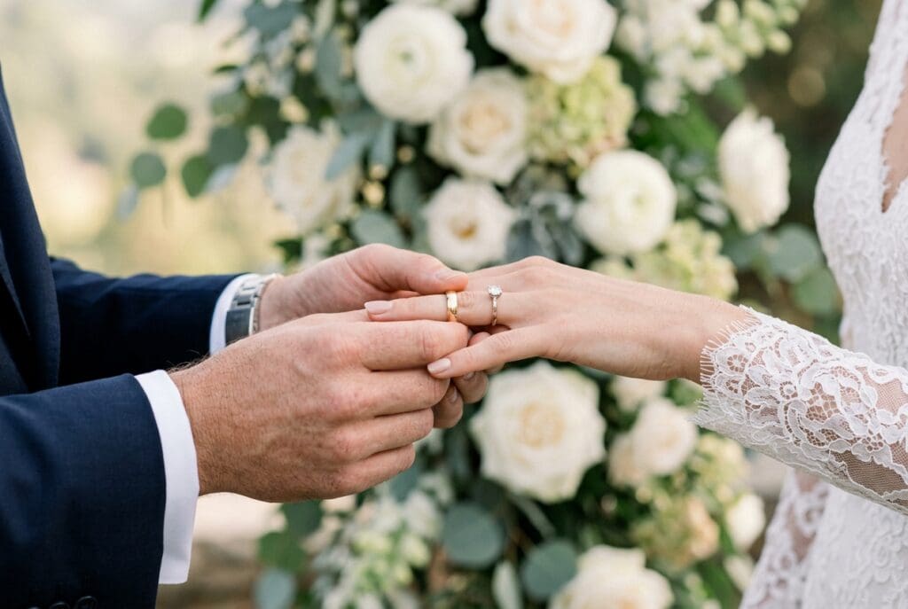 Close-up of a couple exchanging wedding rings during an intimate Yachats Oregon wedding ceremony